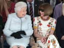 LONDON, ENGLAND - FEBRUARY 20:  Queen Elizabeth II sits next to Anna Wintour as they view Richard Quinn’s runway show before presenting him with the inaugural Queen Elizabeth II Award for British Design as she visits London Fashion Week’s BFC Show Space on February 20, 2018 in London, United Kingdom. (Photo by Yui Mok - Pool/Getty Images)