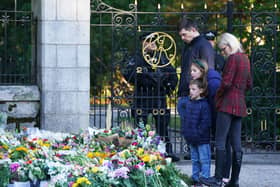 Members of the public look at floral tributes at Balmoral in Scotland following the death of Queen Elizabeth II on Thursday. Picture date: Saturday September 10, 2022. (Photo: PA)