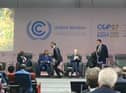 Prime Minister Rishi Sunak is seen running off the stage at an event at COP27 in Egypt.
