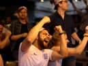 Football fans celebrate while watching the live broadcast of the final of the 2020 UEFA European Championships between England and Italy in the Oxford Arms pub in Camden on July 11, 2021 in London.