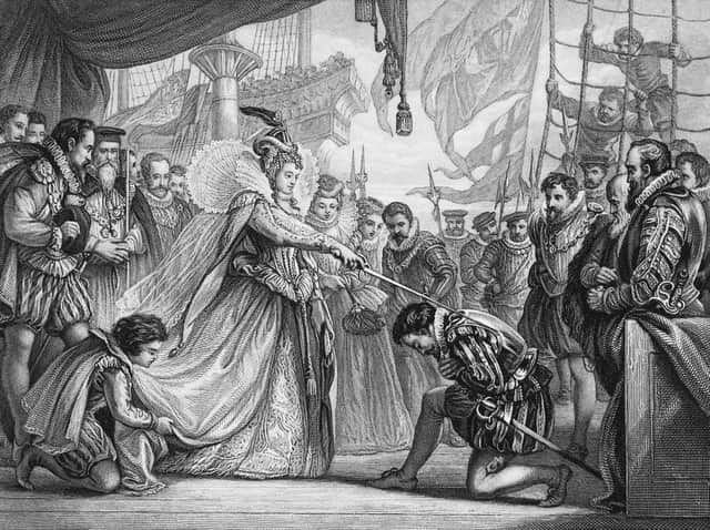 Queen Elizabeth I of England (1533 - 1603) knights explorer Sir Francis Drake (c.1540 - 1596) on board his ship, the Golden Hind at Deptford