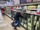 A customer shops for milk inside a Sainsbury's supermarket in east London on February 20, 2023.
