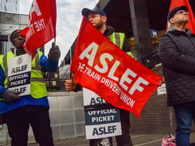 ASLEF (Associated Society of Locomotive Engineers and Firemen) members hold union flags at the picket outside Euston Station as train drivers continue their strike across the UK. (Photo by Vuk Valcic/SOPA Images/LightRocket via Getty Images)