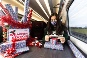 Professional gift wrapper Finn Drumgoole wraps presents for LNER customers to launch the rail operators complimentary Rail Wrapping service (photo: David Parry/PA Wire)