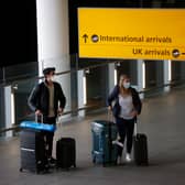 Travellers arrive at Heathrow Airport on January 17, 2021 in London (Photo by Hollie Adams/Getty Images)