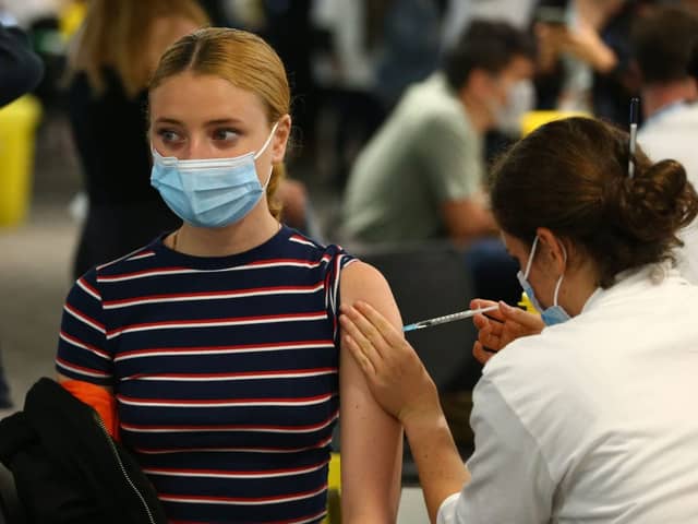 A woman receives a vaccine at the Chelsea F.C. pop up vaccine hub (Photo: Hollie Adams/Getty Images)