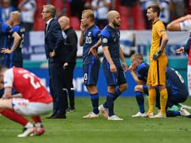 Markku Kanerva, Head Coach of Finland and Teemu Pukki of Finland wait on the pitch as Christian Eriksen (Not pictured) of Denmark receives medical treatment during the UEFA Euro 2020 Championship Group B match between Denmark and Finland on June 12, 2021 in Copenhagen, Denmark. (Photo by Stuart Franklin/Getty Images)