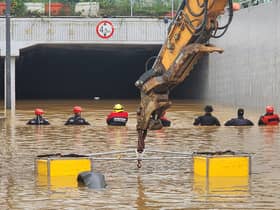 Rescue workers are searching for missing people after a tunnel flooded in South Korea