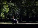 A woman reads a book on a bench in Green Park in central London on September 5, 2023 as the country experiences a late heatwave.