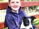 Six-year-old Daniel Mullaney with his parents’ world record price £2,350 pup, Jim