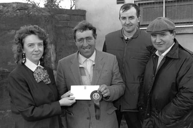 Mary Curran, assistant manager, First Trust, Limavady, sponsors, presenting first prize to Uel Oliver, Ballyleighery, winner of the Suffolk section of the fat lamb show and sale at Limavady Mart. Hugh McCollam, Ballykelly, was second, and Alex McCracken, Magilligan, was third. Picture: Farming Life archives