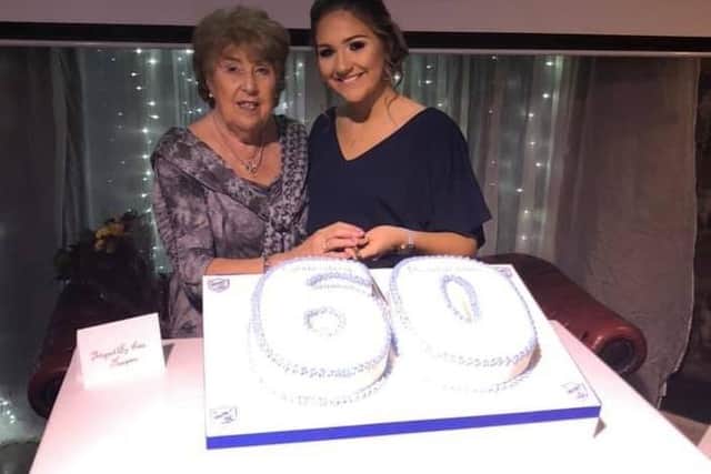 Special guest Anne Speedie and club member Ellen Smyth cut the 60th anniversary cake