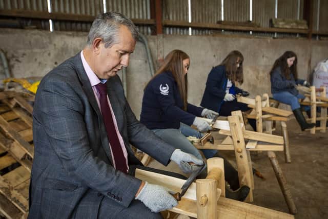 Minister Poots tries his hand at one of Ulster Wildlife's Grassroots Challenge’s wellbeing activities - traditional green woodwork - on his visit to Shamrock Vale Farm