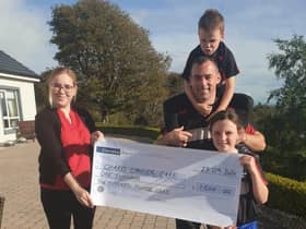 Accepting a cheque on behalf of Charis handed over by Angela McCabe's husband Frank and children Emma and Michael.