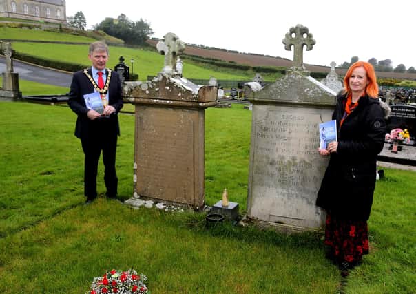 The Mayor of Causeway Coast and Glens Borough Council Alderman Mark Fielding and Rosemary Henderson who wrote the book, pictured at the grave of Sister Molly McGinnis.