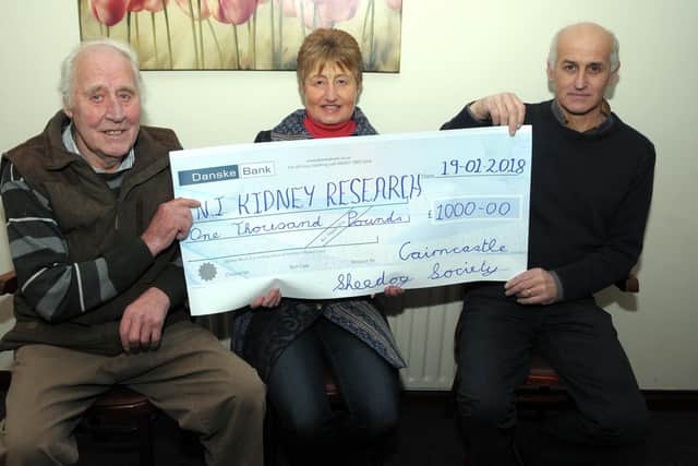 Ben Stewart and Cairncastle Sheepdog Society treasurer, Robert Stewart present Lorraine Harper of Kidney Research NI with a £1,000 cheque from the Cairncastle Sheepdog Society at the final dinner in January 2018. Picture: Larne Times archive