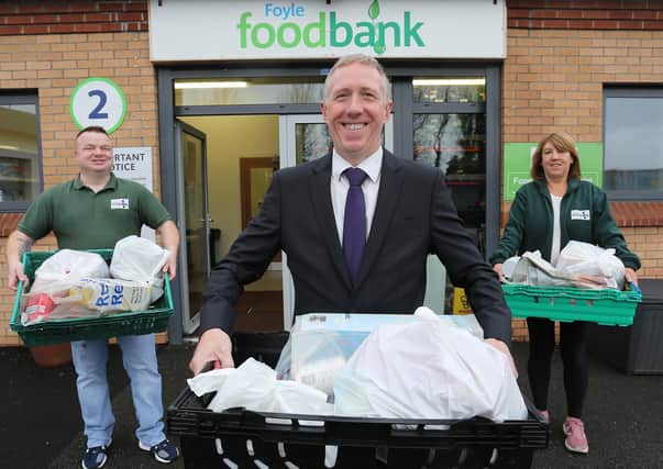 Mark Linton, centre, manager of Ulster Bankâ€TMs Culmore Road branch, gets the partnership underway. He is with James McMenamin, manager, Foyle Foodbank and Louise Kane, Project Worker, Foyle Foodbank.