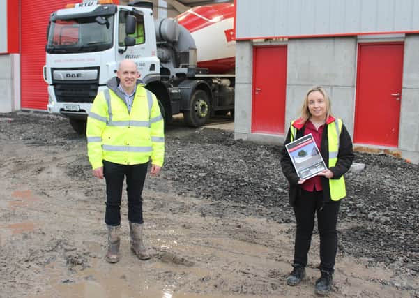 RTU director Franklin McIlroy and Moore Concrete's Nicola McAdam in front of the new workshop at Newtownabbey
