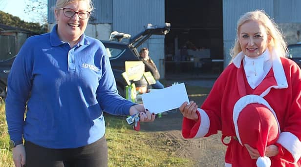 Gillian Orr from Phoenix Gas presents Joan Cunningham, organiser of the Saintfield Christmas Charity Ride with a substantial cheque