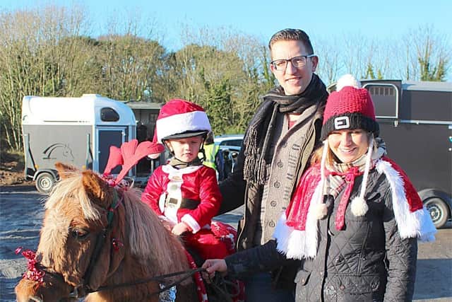 Two-year-old Alexanda Cazauskas with Martynas Cazauskas and Claire Dobbin from Tempo at the Saintfield Christmas Charity Ride