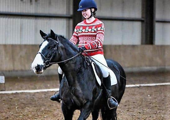 Katie Watt gets her Christmas jumper on to ride Beauty in the walk/trot class - Photo by Equi-Tog
