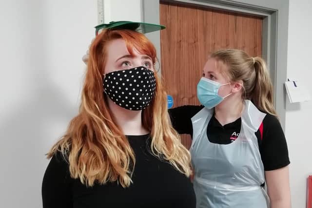 Service user Janine Cousins (left) receives a health check from Health Promotion Student Grace Kennedy dressed in PPE at Action Cancer House in Belfast