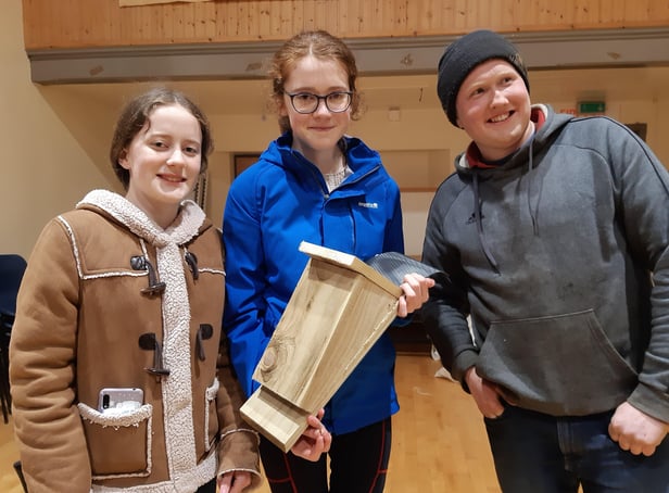 Trillick and District members Amy, Hannah and Colin with their bat box