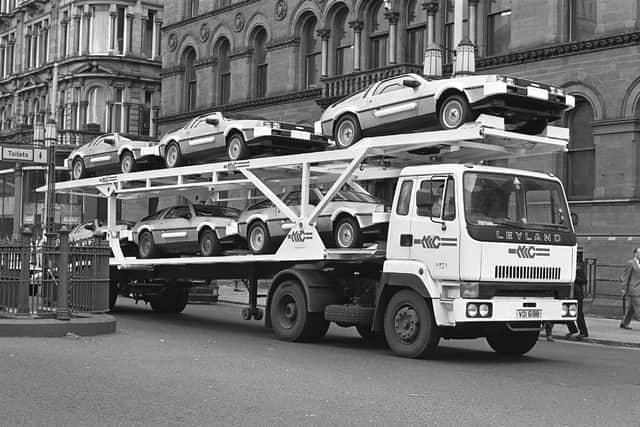 De Lorean cars on a transporter passing through Belfast city centre in June 1981. Picture: Pacemaker Press