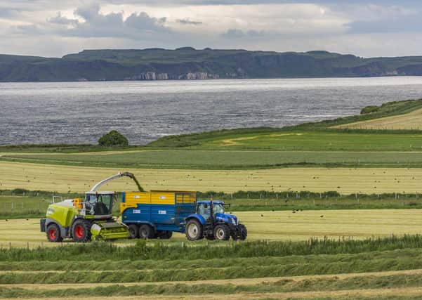 Ballycastle. Northern Ireland. 06.22.16. Agriculture - collecting silage in the fields near Ballycastle in County Antrim, Northern Ireland. Silage is grass fodder that is used as animal feed during the winter.