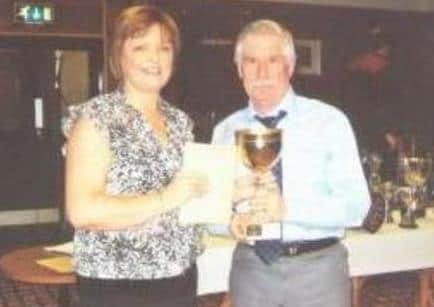 President Tom Service collects the Sennen Cove Nom Cup from Fiona.