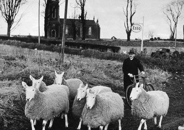 The famed Dervock preacher, sheepbreeder and storyteller the Reverend Robert John McIlmoyle with one of his 'flocks'. His other 'flock' was his congregation at Knockavallen. He was for a long time minister at the Reformed Presbyterian Church at Knockavallen