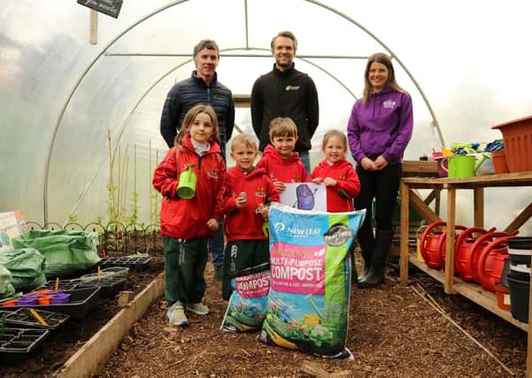 Primary 1 pupils from Friends’ Prep school in Lisburn help to launch the ‘Purple Potato Project’ an initiative set up by Lisburn-based social enterprise Kinder Garden Cooks which has joined with organics recycling firm Natural World Products (NWP) and Patch Seed Potatoes to encourage kids to ‘get growing’.  They are joined by, from left, Colm Warren of NWP, Alex McCreight of Patch Seed Potatoes and Sharon McMaster of Kinder Garden Cooks. The scheme will see 280 pupils across the Lisburn  area receive a bag of New Leaf Compost from NWP, which converts local household food and garden waste into organic, peat-free compost, and a newly-bred purple seed potato from Patch Seed Potatoes. The Purple Potato character is designed by artist Corrina Askin. Photography by Jude Rankin.