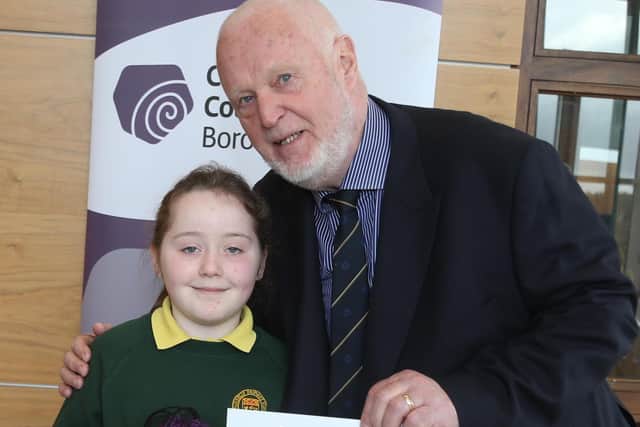 Yasmin Lanout from Ballykelly Primary, winner of the Junior Fairtrade Bake-Off, receive her certificate from Fairtrade Steering Group member Chris McCaughan