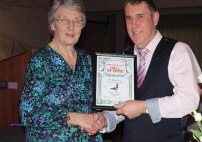 Paul Dunlop from Edgarstown collects his Hall of Fame Diploma from Bessie Morrow at the INFC presentation.