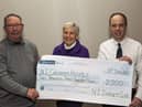 Michael Maybin (President) and Allister McNeill (Chairman) present the cheque to Mrs Rosemary Moore from The Childrens Hospice.