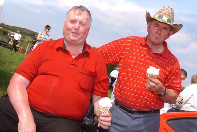 Ernie McLucas, left, and Thomas Arthur enjoy an ice-cream in the Moville sunshine. (1206PG30)