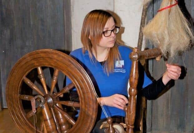 Gillian from the Irish Linen Centre and Lisburn Museum at a spinning wheel. Picture: Irish Linen Centre and Lisburn Museum