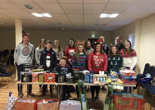 Members from all Co Londonderry clubs, along with Zita McNaugher, YFCU president, handing over presents for the Christmas toy appeal for Cash For Kids