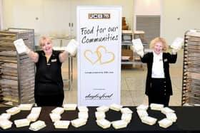 JCB's Louise Fresson, of Caverswall, Stoke-on-Trent, (left) and Hannah Clendon, of Little Haywood, near Stafford, help mark the production of JCB's 10,000th meal for vulnerable people living in the communities around its Staffordshire factories