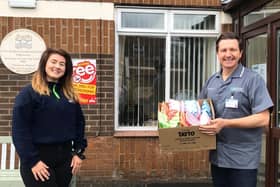 Club member Emma Millar pictured with Roddens Residential home manager Philip Dawson when receiving their stress relief kits