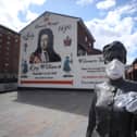 A statue by artist Ross Wilson entitled Mother Daughter Sister, celebrating female identity and culture, in Sandy Row Belfast is adorned with a mask and disposable gloves as the UK heads towards a seventh week in lockdown to try and limit the spread of coronavirus.(Photo: PA Wire)