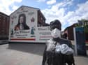 A statue by artist Ross Wilson entitled Mother Daughter Sister, celebrating female identity and culture, in Sandy Row Belfast is adorned with a mask and disposable gloves as the UK heads towards a seventh week in lockdown to try and limit the spread of coronavirus.(Photo: PA Wire)