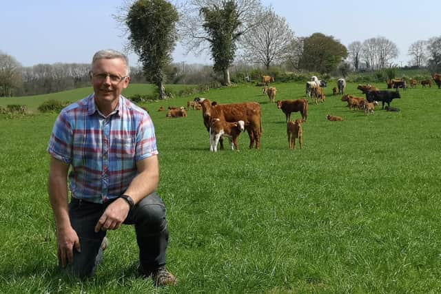 John Egerton pictured with his suckler cows grazing in the background.