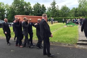 Mourners attending the burial of David Crocket at Burt Presbyterian Church in County Donegal today.