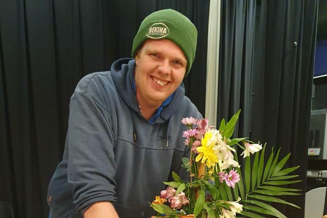 Brian Wade with his third place floral art masterpiece