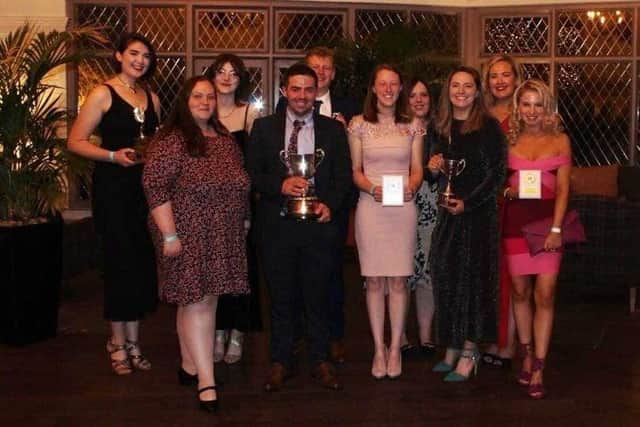 Newtownards YFC members with an array of silverware picked up at the annual Co Down dinner