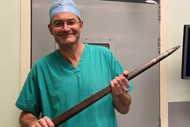Mr Huguet with the tine after it was removed from Jonathan. 
Credit CUH Hospitals.