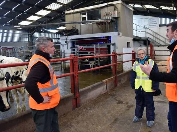 David Paterson AFBI Grassland Agronomist and Steven Morrison AFBI Head of Livestock Production Sciences Branch with Maggie Gill at the Hills Robot milking parlour.