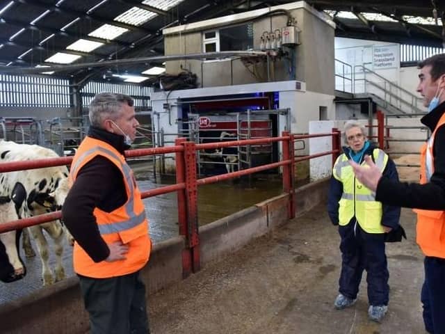 David Paterson AFBI Grassland Agronomist and Steven Morrison AFBI Head of Livestock Production Sciences Branch with Maggie Gill at the Hills Robot milking parlour.