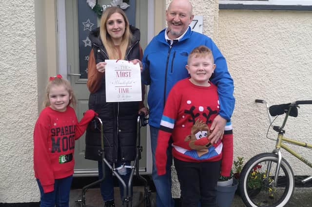 Ronnie Williamson pictured presenting the young lady and family with their Christmas Charity gift